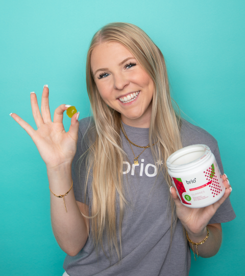 woman getting ready to eat a Brio Nutrition gummie